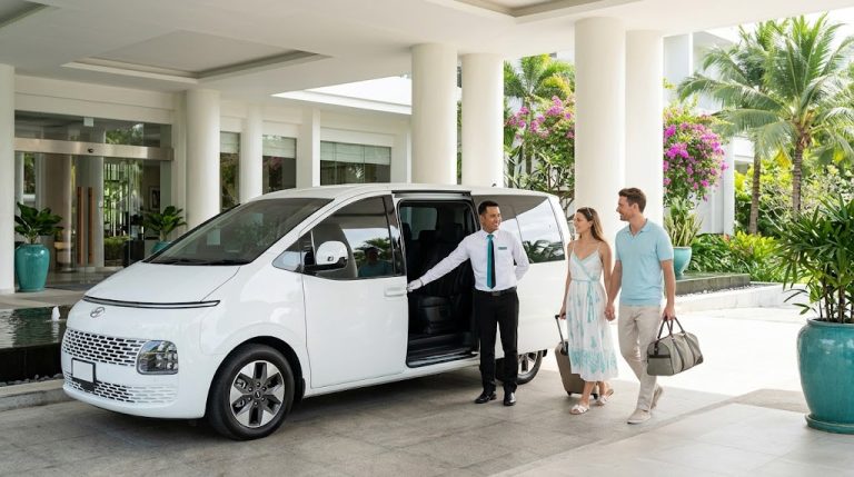 Professional driver assisting guests into a clean private transfer van in Phuket